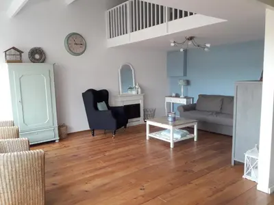 a living room with a couch and a table at Vecht & Weide Weesp in Weesp