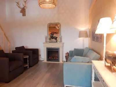 a living room with a couch and a fireplace at Vecht & Weide Weesp in Weesp