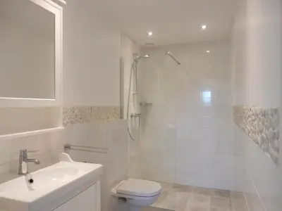 a bathroom with a shower and a toilet and a sink at Vecht & Weide Weesp in Weesp