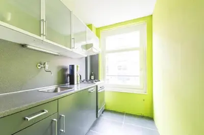 a kitchen with a sink and a window at Jordaan Canal View Apartment in Amsterdam