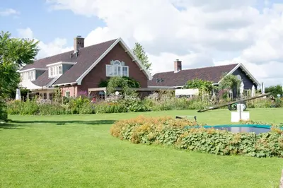 a large house with a yard with a pool at De Sfeerstal in Nieuwveen