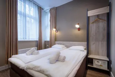 a bedroom with a large bed with white pillows at Amsterdam Downtown Hotel in Amsterdam