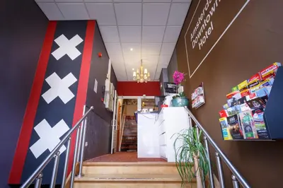 a staircase in a store with a flag on the wall at Amsterdam Downtown Hotel in Amsterdam