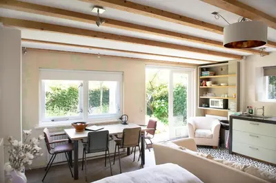 a kitchen and living room with a table and chairs at Family House Amsterdam in Amsterdam