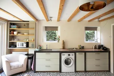 a kitchen with a washer and dryer in a room at Family House Amsterdam in Amsterdam