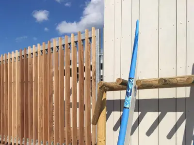a wooden fence with a blue baseball bat next to it at Koningshof in Alkmaar