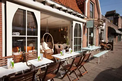 a patio with tables and chairs outside of a restaurant at Koningshof in Alkmaar