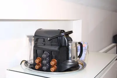 a coffee maker on top of a counter with donuts at Koningshof in Alkmaar