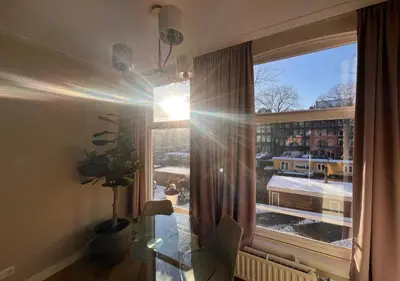 a room with a window with a view of a city at Da Costa Suite in Amsterdam