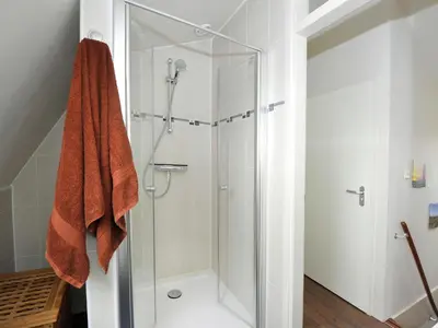 a shower with a glass door in a bathroom at Holiday Home in Noordwijk with Sunny Garden in Noordwijk aan Zee