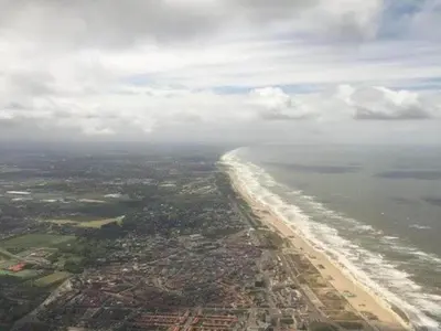 an aerial view of a beach and the ocean at Holiday Home in Noordwijk with Sunny Garden in Noordwijk aan Zee