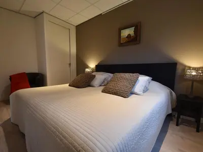 a bedroom with a large white bed with two pillows at Holiday Home in Bergen near Bergerbos Forest in Bergen