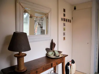 a lamp on a table in a room with a mirror at Holiday Home Noordwijk near the Beach in Noordwijkerhout
