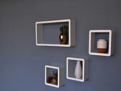 a wall with three framed pictures on a blue wall at Modern Apartment in Noordwijk near the Sea in Noordwijk