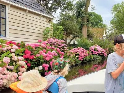 two children looking at flowers in a garden at Cottage in Edam near IJsselmeer Lake in Edam