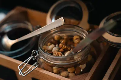 a glass jar filled with nuts in a wooden box at The Hendrick's Hotel in Amsterdam