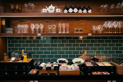 a kitchen with a counter with dishes and glasses at The Hendrick's Hotel in Amsterdam