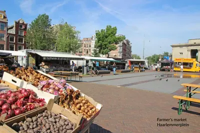 a market with boxes of vegetables on a city street at Guesthouse Prinsencanal 1 in Amsterdam