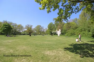 a group of people in a park with a statue at Guesthouse Prinsencanal 1 in Amsterdam