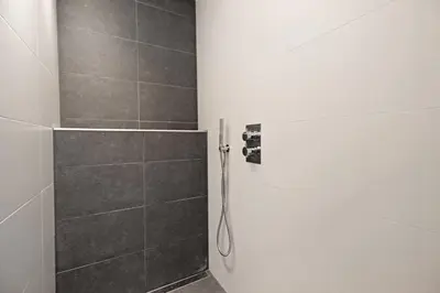 a bathroom with a shower with a shower head at Guesthouse Prinsencanal 2 in Amsterdam