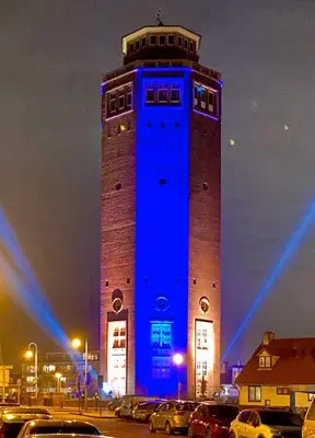 a large tower with a blue light at night at Benny's Beach House 1 in Zandvoort