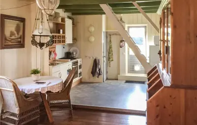 a kitchen with a table and chairs in a room at De Bedstee in Opperdoes