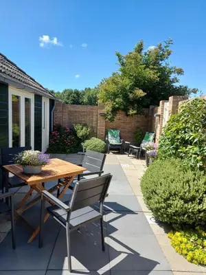 a patio with a wooden table and chairs at Holiday Home Canal View in Alkmaar
