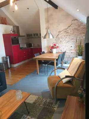 a living room with a table and a brick wall at Holiday Home Canal View in Alkmaar