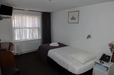 a hotel room with a bed and a window at Hotel de Gaaper in Amersfoort