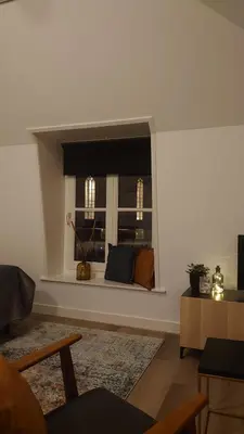 a living room with a window with a couch at Hotel de Gaaper in Amersfoort