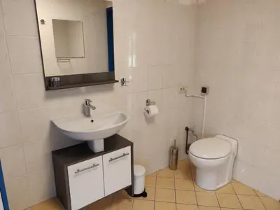 a bathroom with a sink and a toilet at Guest House Ons Hoekje in Houten