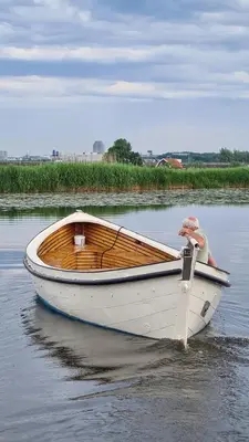 a man sitting in a boat on the water at Boutique hotel Villa Oldenhoff in Abcoude