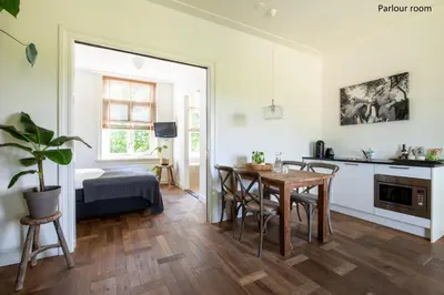 a kitchen and dining room with a table and chairs at Boutique hotel Villa Oldenhoff in Abcoude