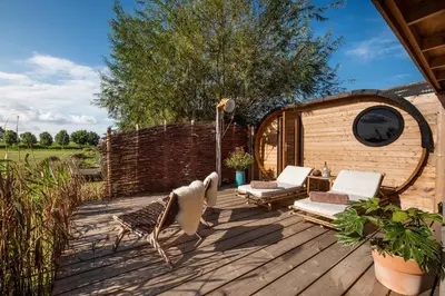 a deck with chairs and a gazebo at Boutique hotel Villa Oldenhoff in Abcoude