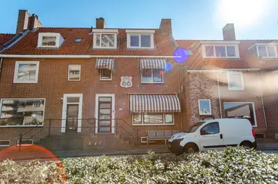 a white van parked in front of a brick building at Pension Sixtysix in Zandvoort