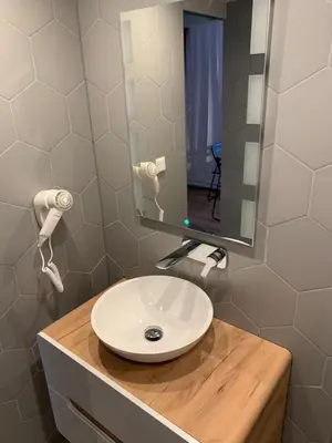 a bathroom with a white sink and a mirror at Hotel Restaurant Old Bridge in Amsterdam
