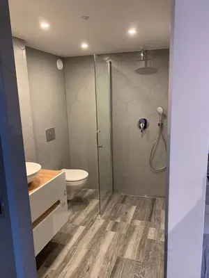 a bathroom with a toilet and a glass shower at Hotel Restaurant Old Bridge in Amsterdam