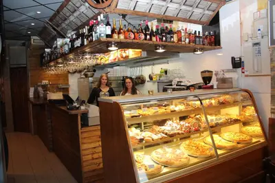 two women standing behind a counter in a bakery at Hotel Restaurant Old Bridge in Amsterdam
