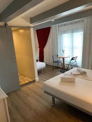 a hotel room with a bed and a table with chairs at Hotel Restaurant Old Bridge in Amsterdam