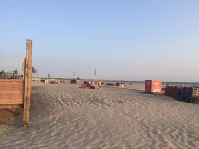 a beach with a wooden structure on the sand at Chalet Jade in IJmuiden