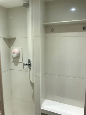 a white bathroom with a shower with a toilet at Amsterdam Red Light Bed & Breakfast in Amsterdam