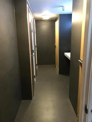 a hallway of a bathroom with two doors and a sink at Amsterdam Red Light Bed & Breakfast in Amsterdam