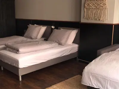 two beds in a room with white sheets and pillows at Amsterdam Red Light Bed & Breakfast in Amsterdam