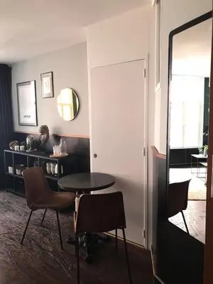 a room with a table and chairs and a mirror at Amsterdam Red Light Bed & Breakfast in Amsterdam