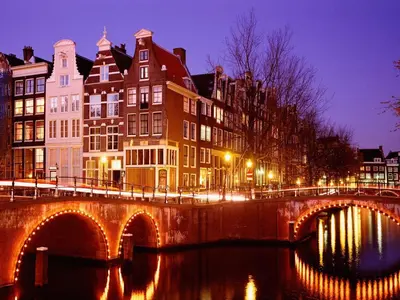 a bridge over a river in a city at night at B&B-Edam in Edam