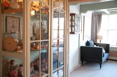 a room with a glass cabinet filled with toys at B&B Herengracht 21 in Amsterdam