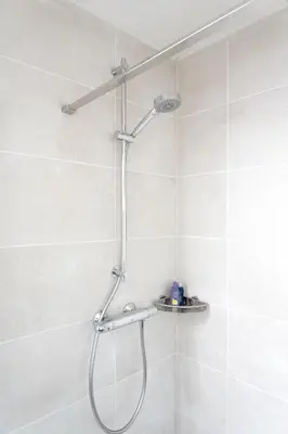 a shower with a shower head in a bathroom at NEW Appartment Zandvoort! in Zandvoort