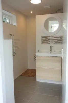 a bathroom with a sink and a mirror at The Beach House in Noordwijkerhout