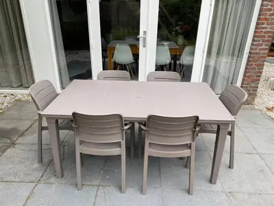 a white table and chairs on a patio at The Beach House in Noordwijkerhout
