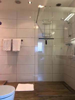 a bathroom with a shower with a glass door at Appartement Modern Egmond in Egmond aan Zee